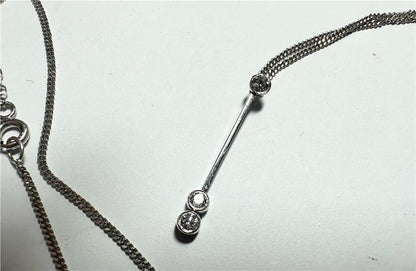 9ct white gold chain with 18ct white gold diamond pendant, showcasing a sparkling pendant on a delicate gold chain.