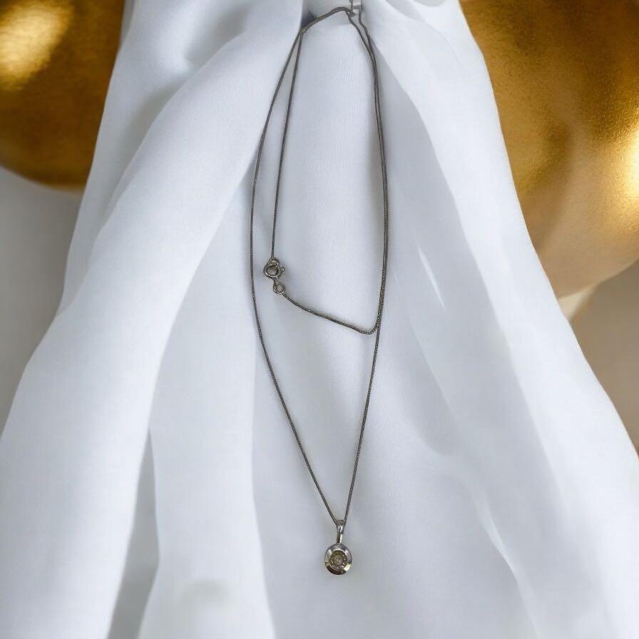 9ct white gold chain with pendant, unbranded jewelry, featuring a sleek and elegant design visible in the image.