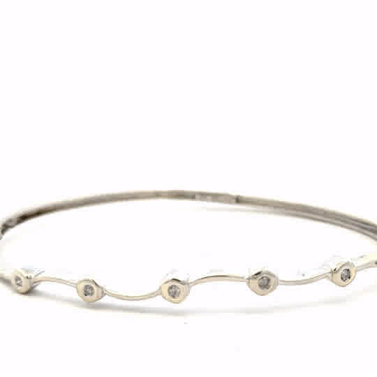 9ct white gold diamond bangle bracelet with sparkling diamonds, weighing 7.7g, unbranded jewelry piece.