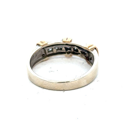 9ct white gold diamond ring with a central sparkling diamond and intricate band design, showcasing elegant jewelry craftsmanship.