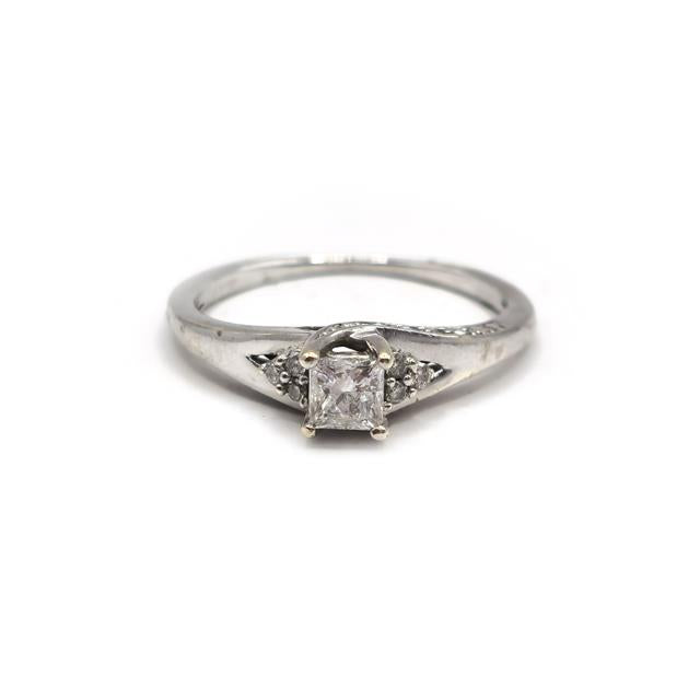 9ct white gold diamond ring with a sparkling central diamond and delicate band, showcasing elegant jewelry craftsmanship.