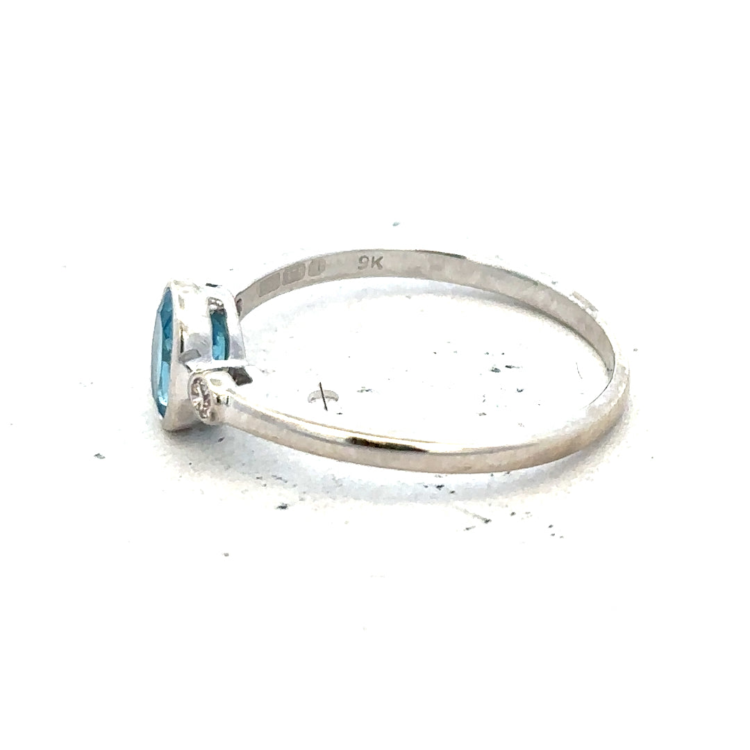 9ct white gold topaz and diamond ring in size Q, featuring a sparkling gemstone and elegant design.