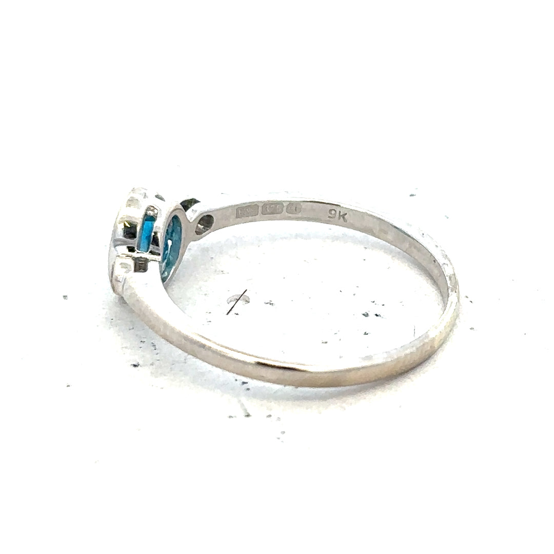 9ct white gold topaz and diamond ring in size Q, showcasing a sparkling blue topaz center stone with diamond accents.