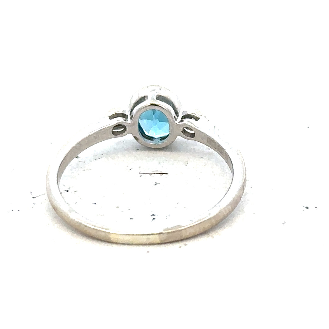 9ct white gold ring with a blue topaz and diamond accents, size Q, featuring a elegant design and sparkling gemstones.
