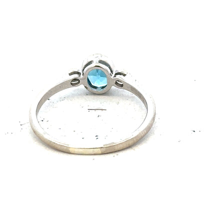 9ct white gold ring with a blue topaz and diamond accents, size Q, featuring a elegant design and sparkling gemstones.