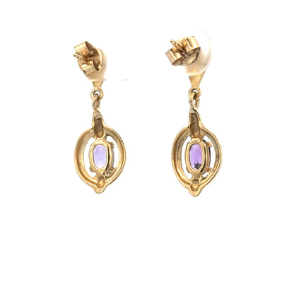 9ct yellow gold amethyst earrings featuring purple gemstones set in elegant gold, weighing 2.1g.