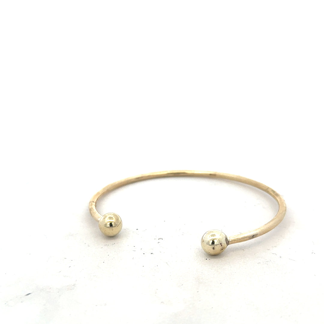 9ct yellow gold bangle bracelet weighing 12.7g, unbranded, featuring a smooth, polished finish and classic design.