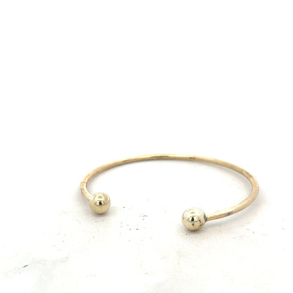 9ct yellow gold bangle bracelet weighing 12.7g, unbranded, featuring a smooth, polished finish and classic design.