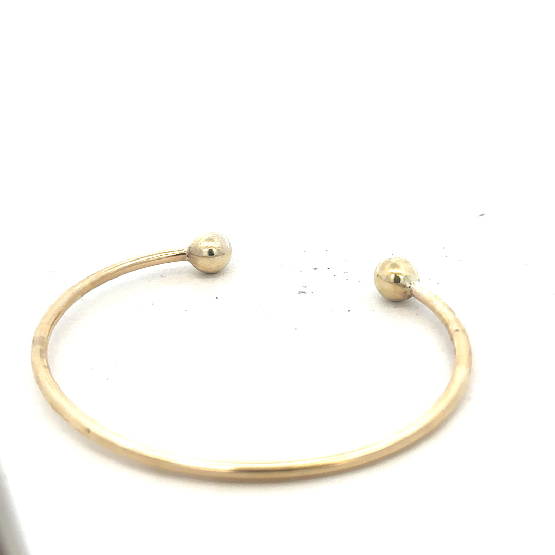 9ct yellow gold bracelet bangle weighing 12.7g, unbranded, with a smooth, rounded design and secure clasp.