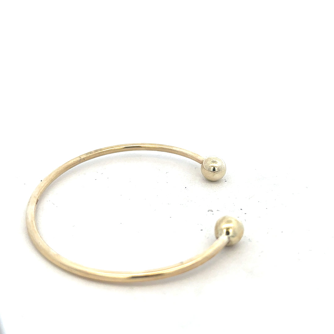 9ct yellow gold bangle bracelet weighing 12.7g, unbranded, with a smooth polished finish visible in the image.