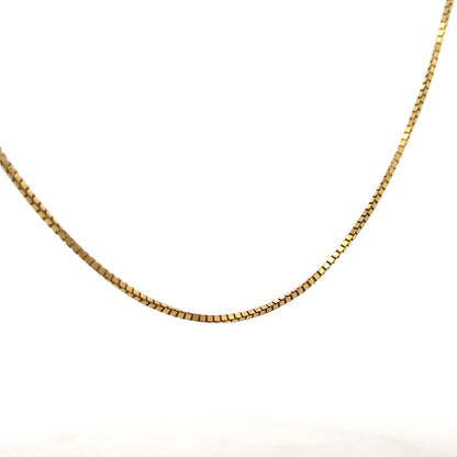 9ct yellow gold box chain, unbranded, 6.4g, close-up of the sleek chain with rectangular links on a plain background.