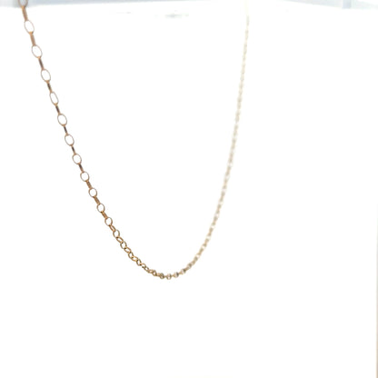 9ct yellow gold chain weighing 0.7g, unbranded jewelry chain, close-up view showing fine link details and polished surface.