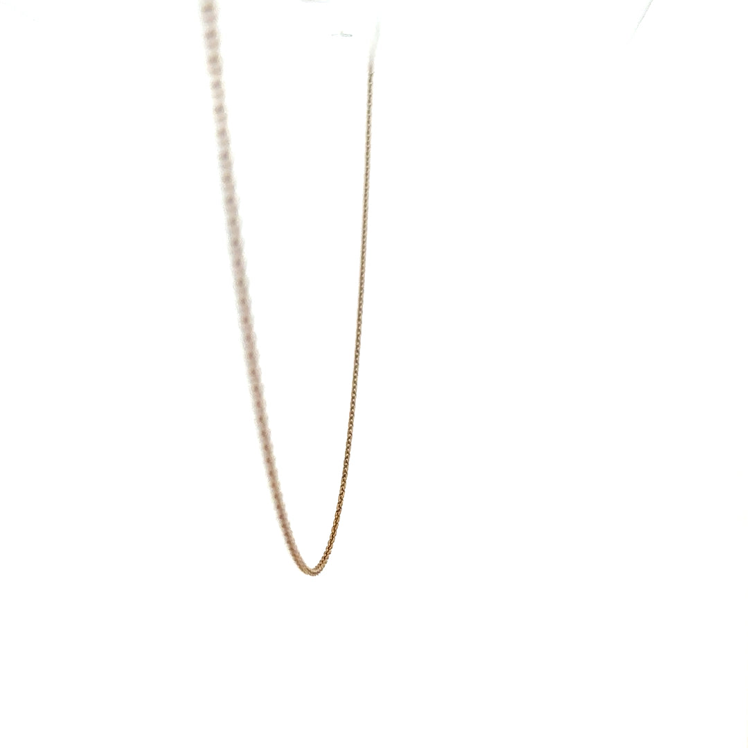 9ct yellow gold chain weighing 1.3g, unbranded, with a detailed close-up of the chain's links and shine.