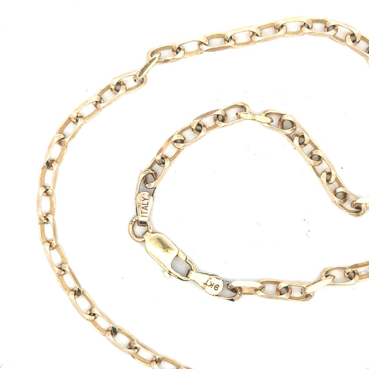 9ct yellow gold chain weighing 10.9g, unbranded, shown in a detailed close-up highlighting the chain's links and gold finish.