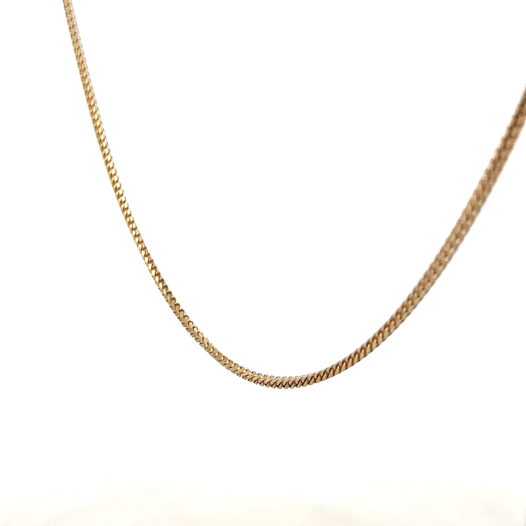9ct yellow gold chain weighing 9.2g, unbranded jewelry with a classic design, shown in close-up detail.