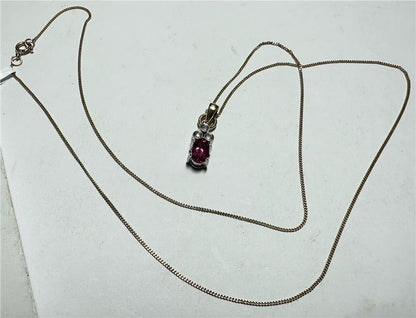 9ct yellow gold chain with diamond pendant, featuring a delicate design and sparkling stones, weighs approximately 1.9 grams.
