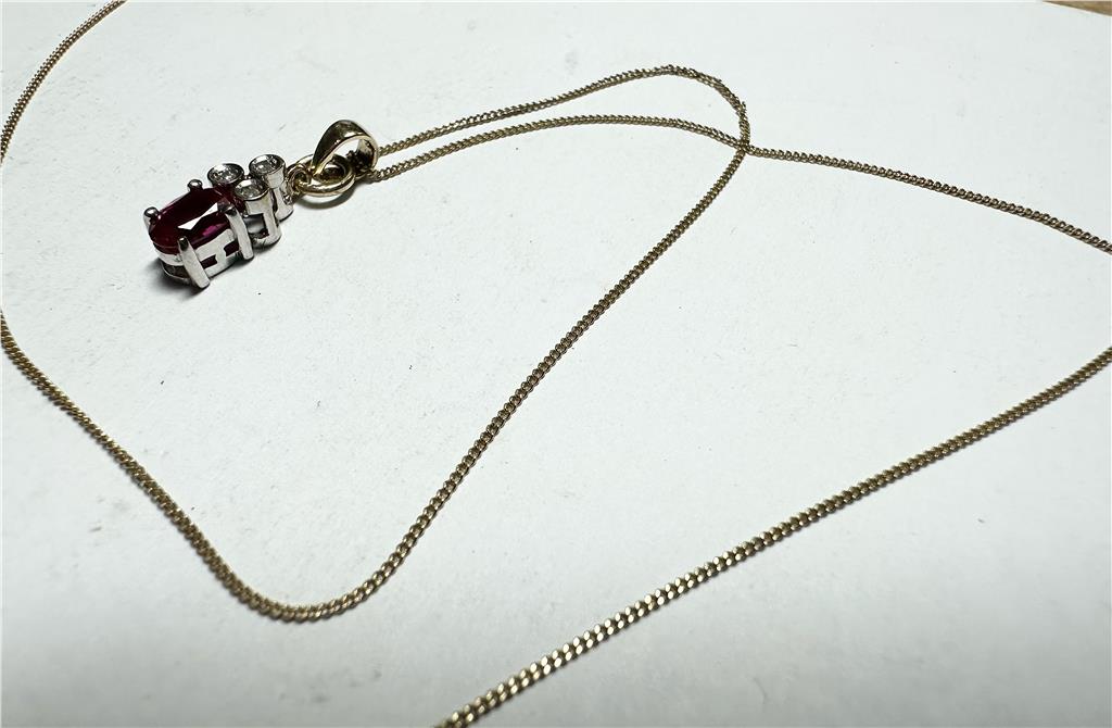 9ct yellow gold chain with diamond pendant, showcasing a delicate design and sparkling gemstone on a fine jewelry chain.