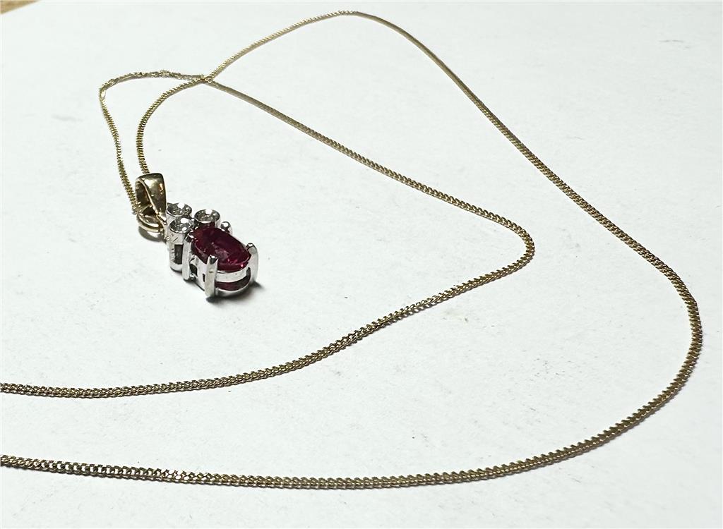 9ct yellow gold chain with diamond pendant, showcasing a delicate chain and sparkling pendant on a plain background.