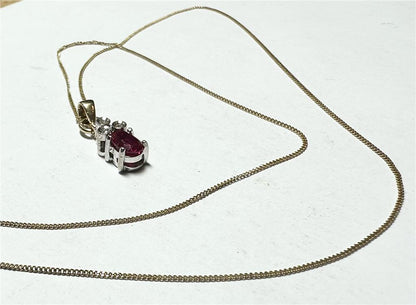 9ct yellow gold chain with diamond pendant, showcasing a delicate chain and sparkling pendant on a plain background.