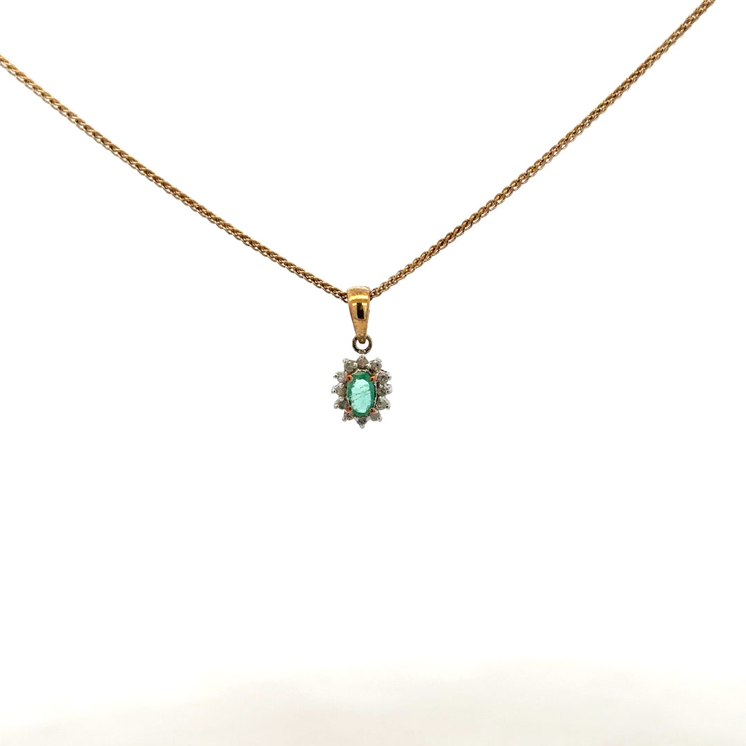 9ct yellow gold chain with emerald and diamond pendant, showcasing a delicate, elegant jewelry piece with vibrant gemstones.