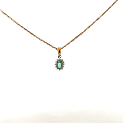 9ct yellow gold chain with emerald and diamond pendant, showcasing a delicate, elegant jewelry piece with vibrant gemstones.