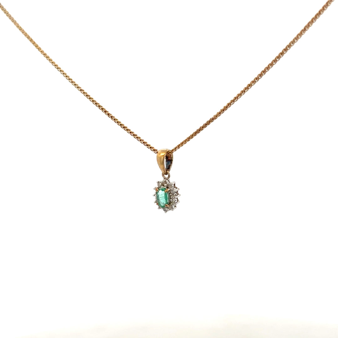9ct yellow gold chain with emerald and diamond pendant, featuring a delicate design and polished finish.