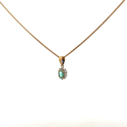 9ct yellow gold chain with emerald and diamond pendant, featuring a delicate design and polished finish.