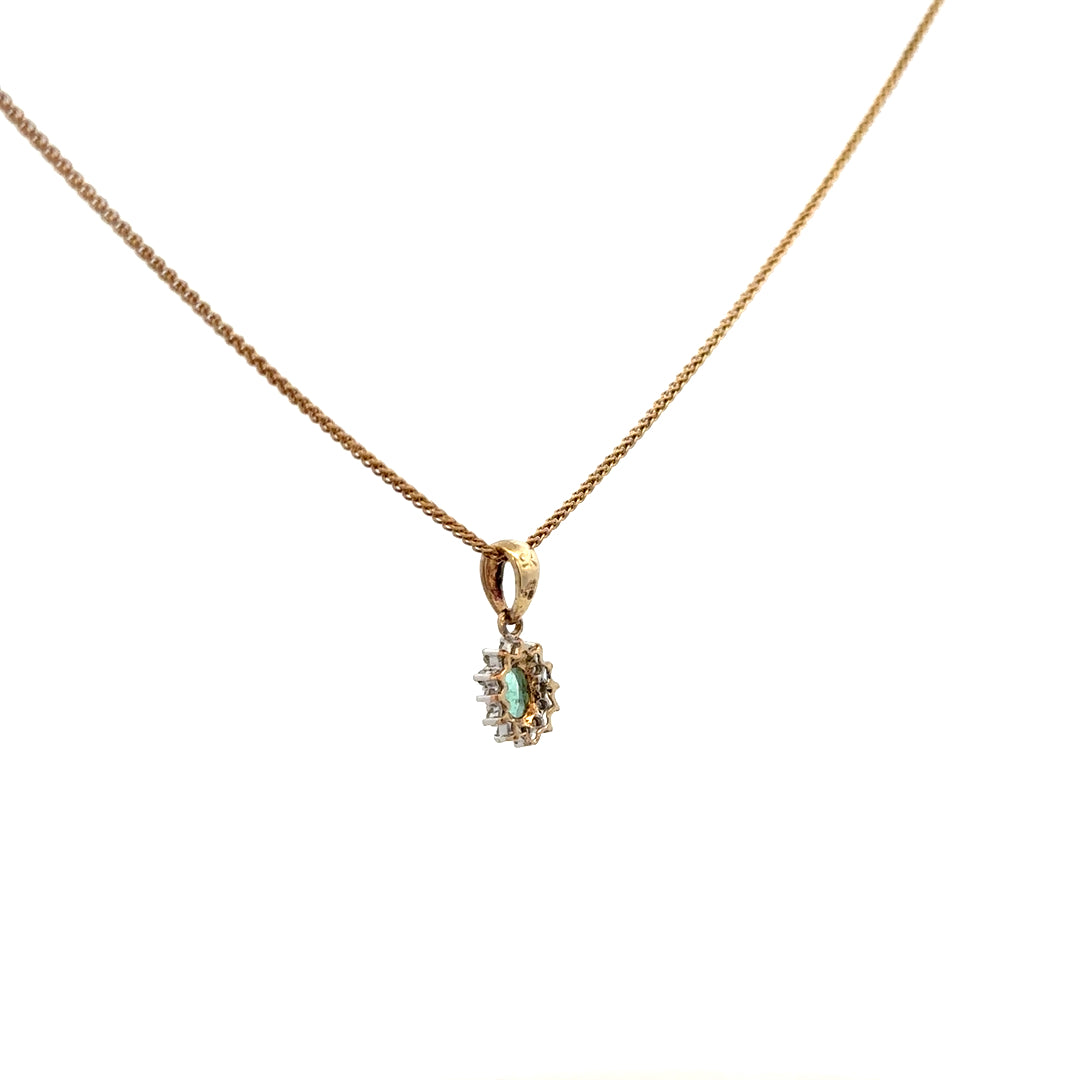 9ct yellow gold chain with emerald and diamond pendant, showcasing a delicate design and vibrant gemstones.