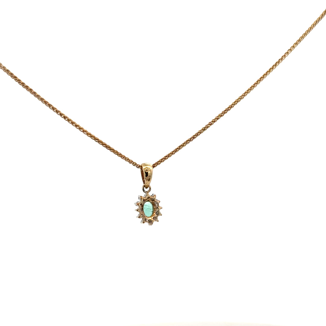 9ct yellow gold chain with emerald and diamond pendant, showcasing a delicate design and vibrant gemstones.