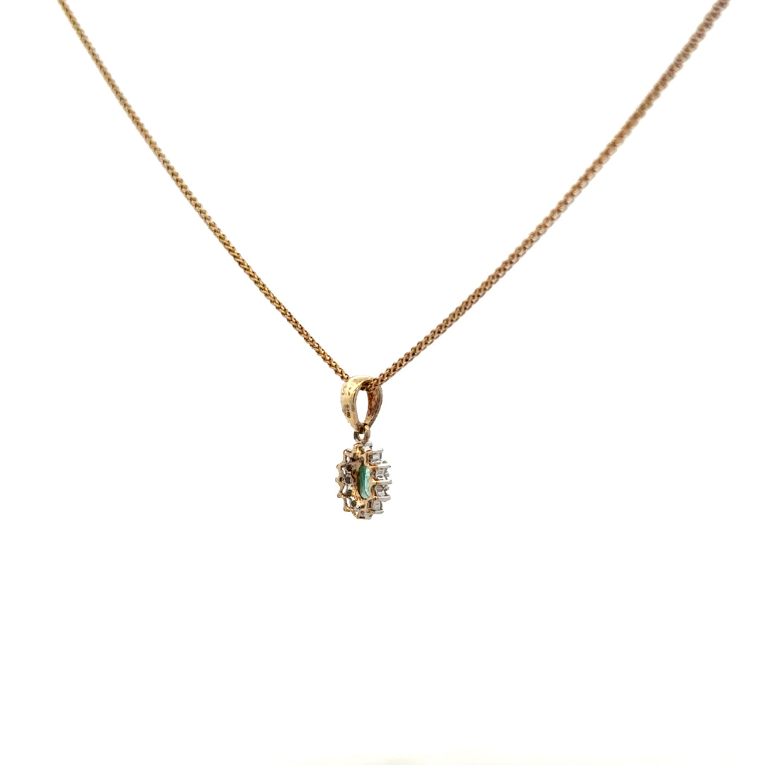 9ct yellow gold chain with emerald and diamond pendant, showcasing a detailed gemstone design and elegant craftsmanship.