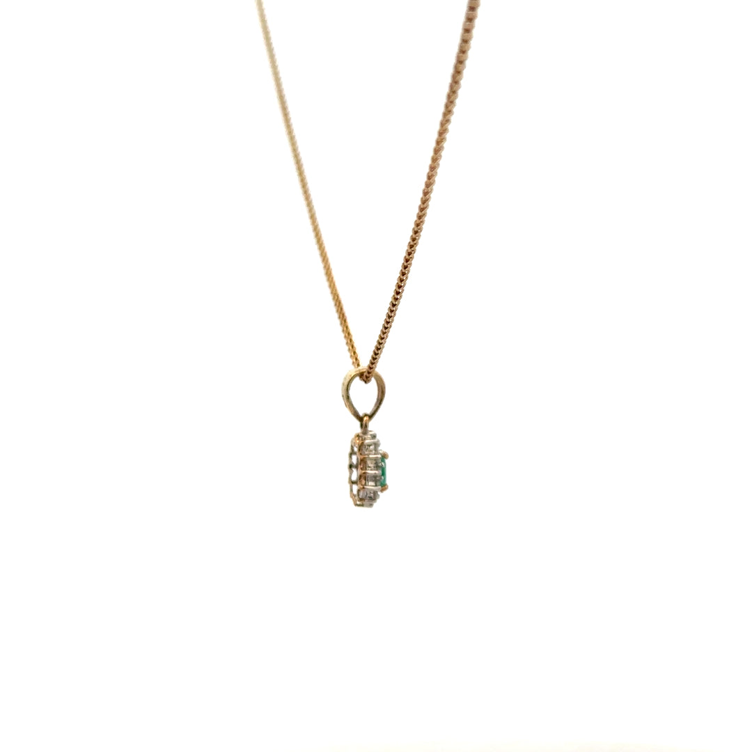 9ct yellow gold chain with emerald and diamond pendant, featuring a delicate design and vibrant gemstone accents.
