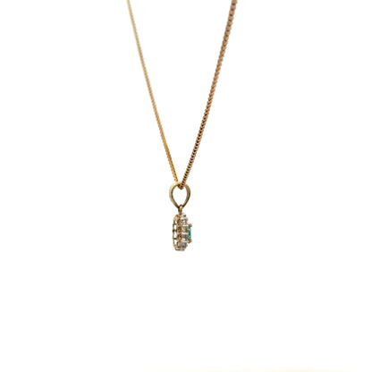 9ct yellow gold chain with emerald and diamond pendant, featuring a delicate design and vibrant gemstone accents.