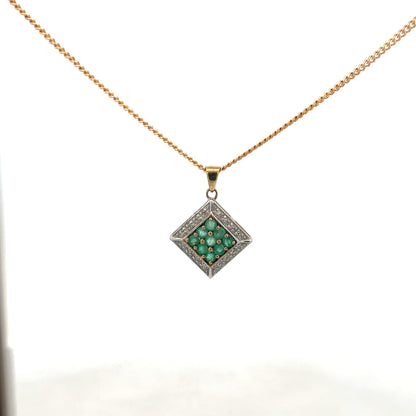 9ct yellow gold chain with emerald and diamond pendant, featuring intricate design and sparkling gemstones.
