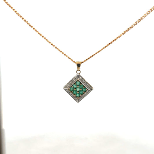 9ct yellow gold chain with emerald and diamond pendant, featuring intricate design and sparkling gemstones.