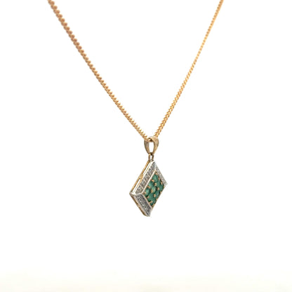 9ct yellow gold chain with emerald and diamond pendant, showing the elegant jewelry piece with detailed gemstones.