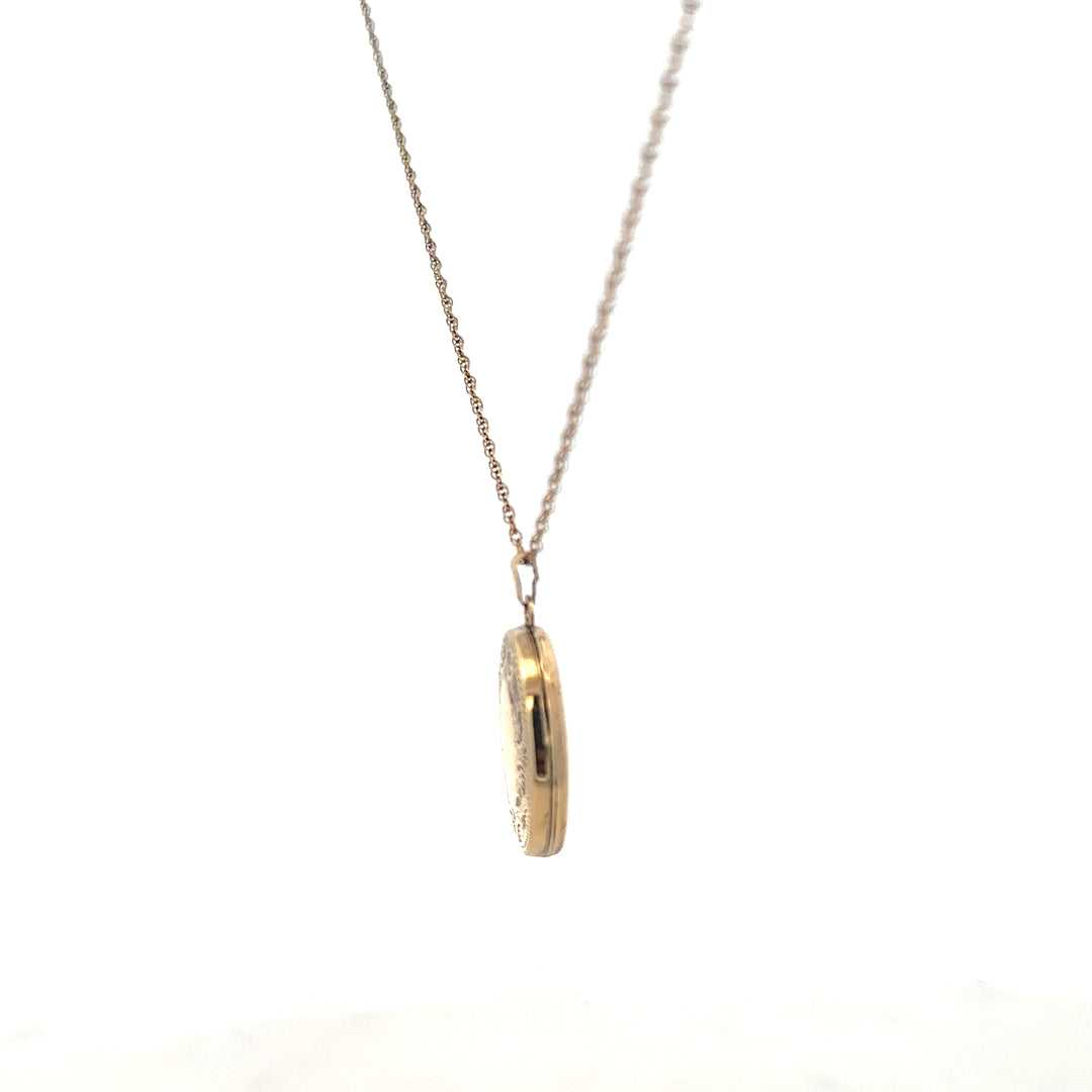9ct yellow gold chain with locket pendant, unbranded, weighing 2.9g, displayed with intricate details on the pendant.