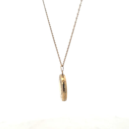 9ct yellow gold chain with locket pendant, unbranded, weighing 2.9g, displayed with intricate details on the pendant.