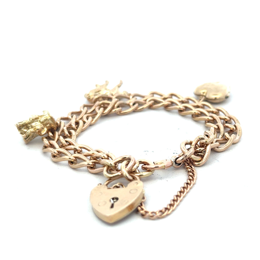 9ct yellow gold charm bracelet with intricate details, weighing 28.5g, unbranded jewelry accessory.