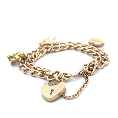 9ct yellow gold charm bracelet with intricate details, weighing 28.5g, unbranded jewelry accessory.