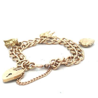 9ct yellow gold charm bracelet weighing 28.5g, featuring decorative charms and a secure clasp, unbranded jewelry accessory.