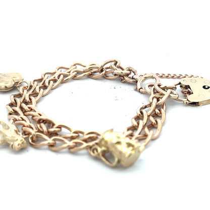 9ct yellow gold charm bracelet with detailed charms, weighs 28.5g, unbranded, showcasing intricate gold jewelry design
