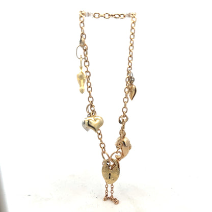 9ct yellow gold charm bracelet weighing 5.4g, unbranded, featuring delicate chain links and small decorative charms.
