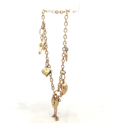 9ct yellow gold charm bracelet weighing 5.4g, unbranded, featuring delicate gold charms and fine chain detail.