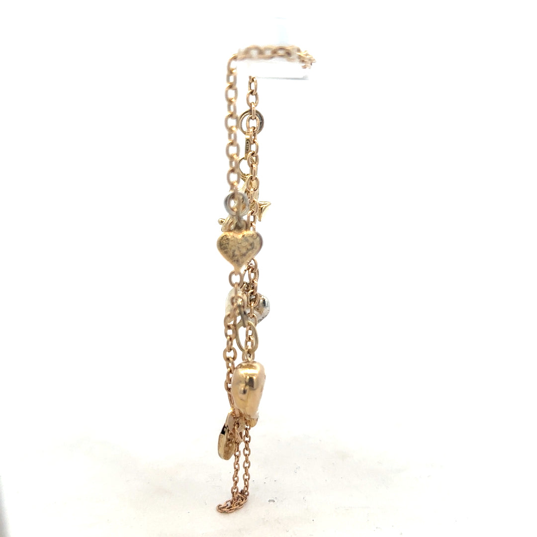 9ct yellow gold charm bracelet weighing 5.4g, unbranded, with decorative charms, displayed on a plain background.