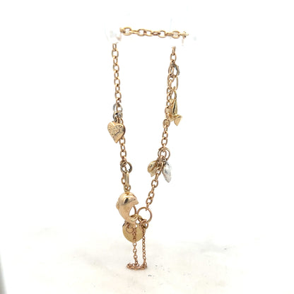 9ct yellow gold charm bracelet weighing 5.4g, unbranded, with detailed charms and a secure clasp visible in the image.