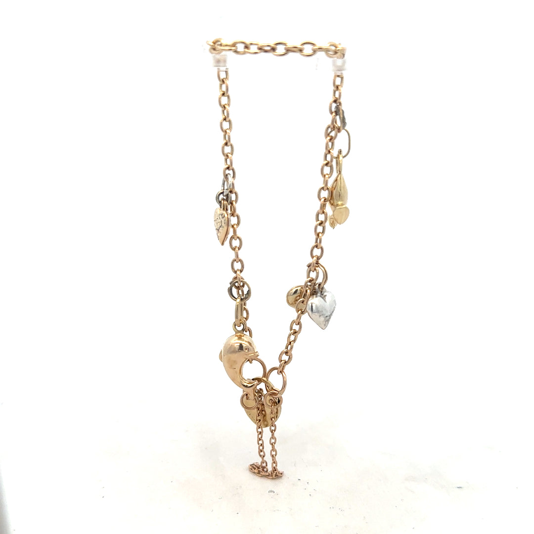 9ct yellow gold charm bracelet with intricate details, weighing 5.4g, featuring various decorative charms on a delicate chain.
