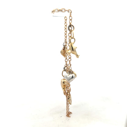 9ct yellow gold charm bracelet with delicate design, weighing 5.4g, featuring small decorative charms on a classic bracelet style.