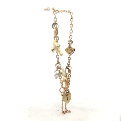 9ct yellow gold charm bracelet with decorative charms, unbranded, weighing 5.4g, shown on a neutral background.