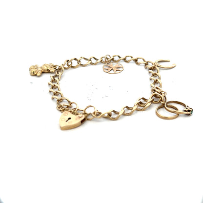9ct yellow gold charm bracelet with intricate design, weighing 9.9g, featuring detailed charms on a linked chain.