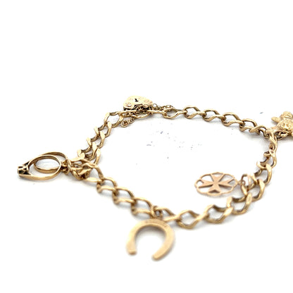 9ct yellow gold charm bracelet with delicate charms, weighing 9.9 grams, unbranded gold jewelry accessory.